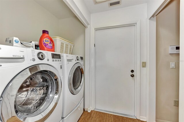 5651 Golf Pointe Dr Unit 5651, Sarasota, FL 34243 - laundry room featuring independent washer and dryer and wood finished floors