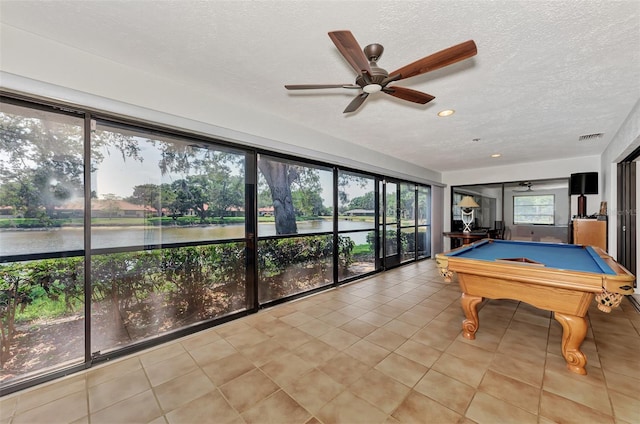 5651 Golf Pointe Dr Unit 5651, Sarasota, FL 34243 - playroom with a water view, ceiling fan, a textured ceiling, billiards table, and tile patterned floors