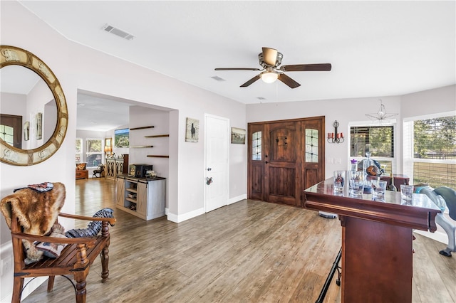 12714 Tyler Run Ave, Odessa, FL 33556 - entrance foyer with a ceiling fan, wood finished floors, and baseboards
