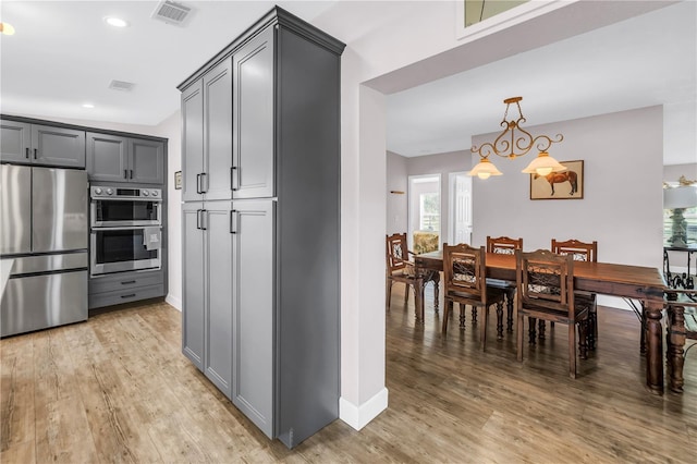 12714 Tyler Run Ave, Odessa, FL 33556 - kitchen featuring appliances with stainless steel finishes, gray cabinetry, light wood-type flooring, baseboards, and recessed lighting