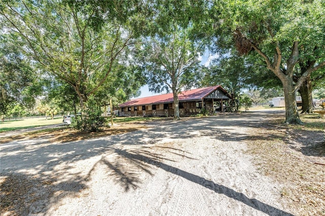 12714 Tyler Run Ave, Odessa, FL 33556 - ranch-style house with metal roof and dirt driveway