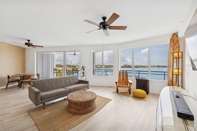 516 Tamiami Trl S Unit 306, Nokomis, FL 34275 - living room featuring ceiling fan, light wood-style floors, and baseboards