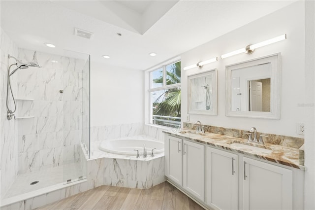 516 Tamiami Trl S Unit 306, Nokomis, FL 34275 - bathroom with a garden tub, a marble finish shower, double vanity, wood finished floors, and recessed lighting