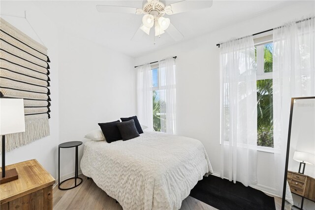 516 Tamiami Trl S Unit 306, Nokomis, FL 34275 - bedroom featuring wood finished floors, baseboards, and ceiling fan
