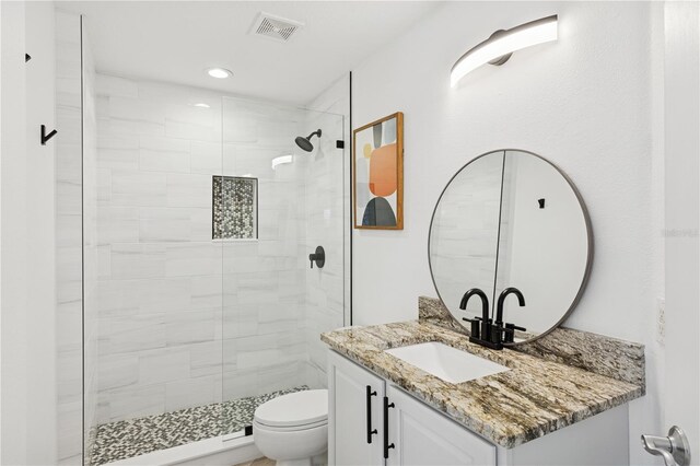 516 Tamiami Trl S Unit 306, Nokomis, FL 34275 - full bath featuring toilet, vanity, a tile shower, and recessed lighting