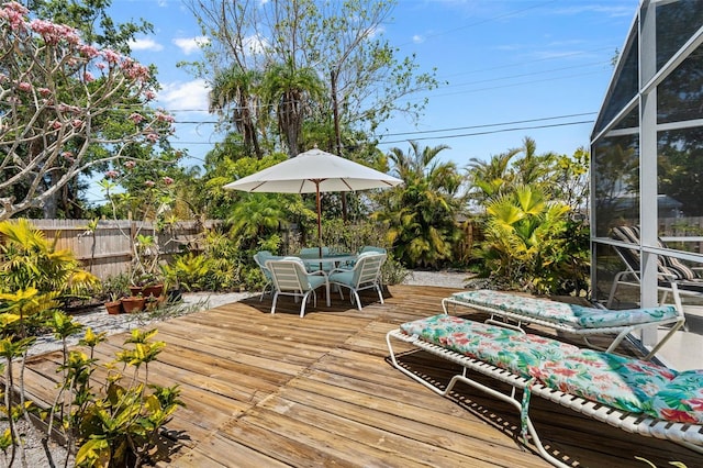 139 Adair Ave, Sarasota, FL 34243 - deck featuring a fenced backyard, glass enclosure, and outdoor dining space
