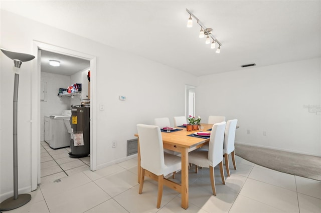 139 Adair Ave, Sarasota, FL 34243 - dining room featuring washer and dryer, electric water heater, light tile patterned floors, and baseboards