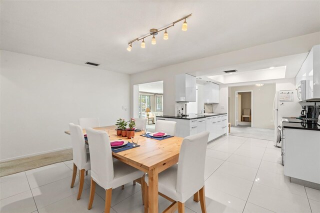 139 Adair Ave, Sarasota, FL 34243 - dining room with light tile patterned flooring and baseboards