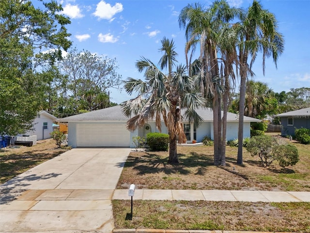 139 Adair Ave, Sarasota, FL 34243 - view of property hidden behind natural elements with an attached garage, driveway, and stucco siding
