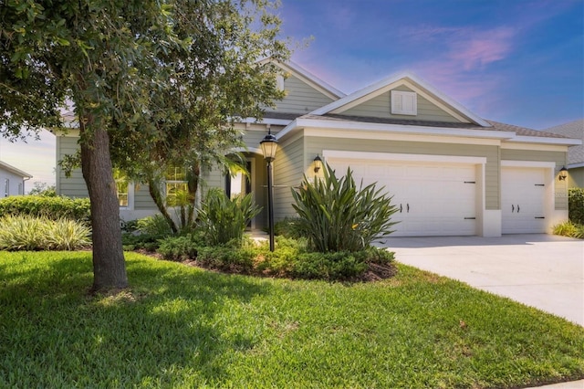 16943 Rosedown Gln, Parrish, FL 34219 - view of front facade featuring concrete driveway, a garage, and a front lawn