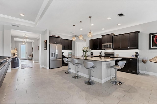 16943 Rosedown Gln, Parrish, FL 34219 - kitchen with appliances with stainless steel finishes, a kitchen bar, a chandelier, recessed lighting, and dark brown cabinets