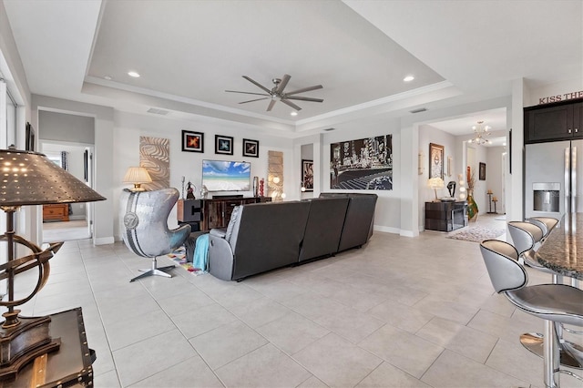 16943 Rosedown Gln, Parrish, FL 34219 - living room featuring a raised ceiling, ceiling fan, recessed lighting, light tile patterned flooring, and baseboards