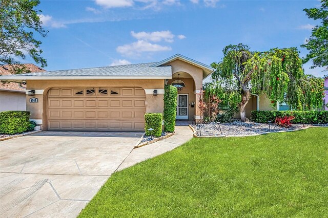 5742 39th Street Cir E, Bradenton, FL 34203 - view of front of house with driveway, stucco siding, a garage, and a front yard