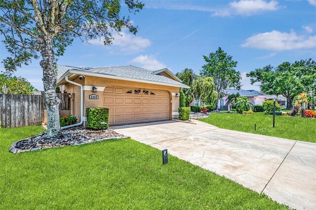 5742 39th Street Cir E, Bradenton, FL 34203 - ranch-style house with concrete driveway, an attached garage, stucco siding, and roof with shingles
