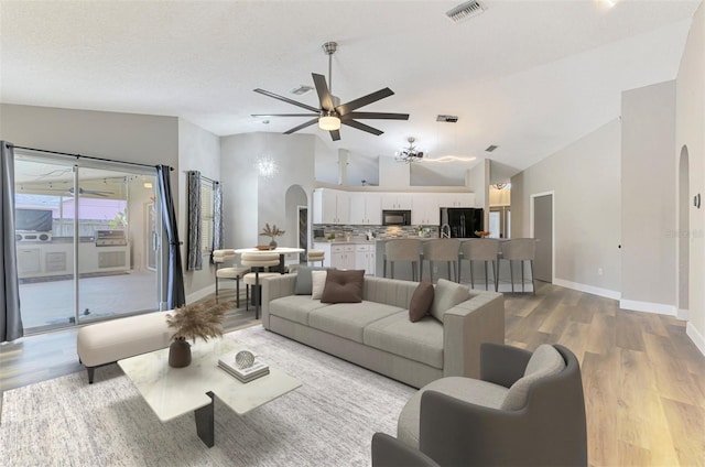 5742 39th Street Cir E, Bradenton, FL 34203 - living room with arched walkways, lofted ceiling, light wood-type flooring, ceiling fan, and baseboards