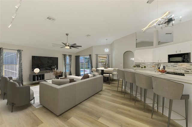 5742 39th Street Cir E, Bradenton, FL 34203 - living room featuring lofted ceiling, light wood-style flooring, a ceiling fan, and track lighting
