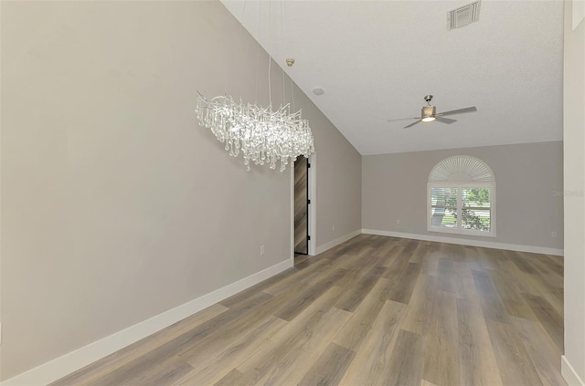 5742 39th Street Cir E, Bradenton, FL 34203 - spare room featuring a ceiling fan, wood finished floors, a chandelier, baseboards, and lofted ceiling