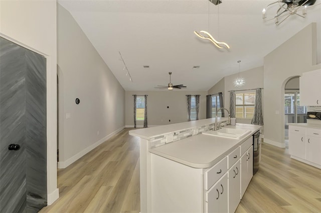 5742 39th Street Cir E, Bradenton, FL 34203 - kitchen featuring a sink, light wood-style flooring, white cabinets, a kitchen island with sink, and high vaulted ceiling