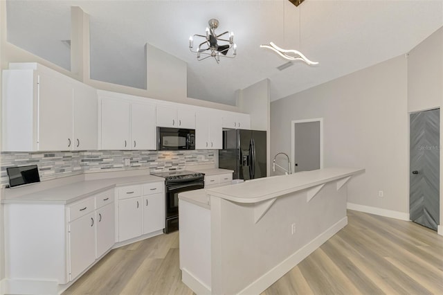 5742 39th Street Cir E, Bradenton, FL 34203 - kitchen with black appliances, a chandelier, tasteful backsplash, light wood finished floors, and white cabinets