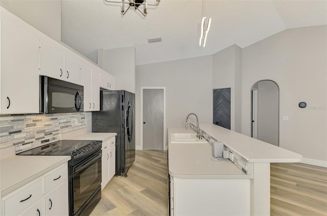 5742 39th Street Cir E, Bradenton, FL 34203 - kitchen with black appliances, lofted ceiling, a sink, decorative backsplash, and light countertops