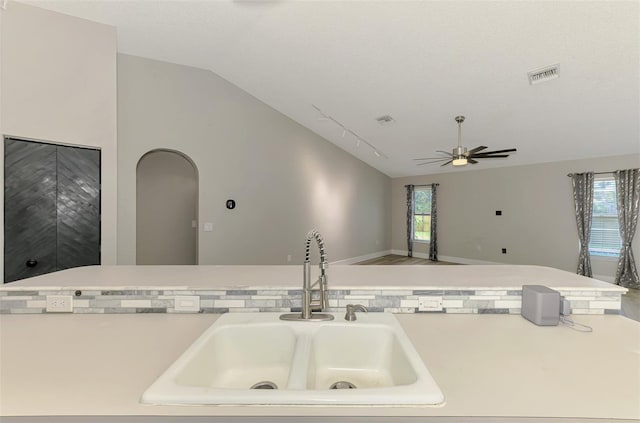 5742 39th Street Cir E, Bradenton, FL 34203 - kitchen with vaulted ceiling, a sink, plenty of natural light, light countertops, and a ceiling fan