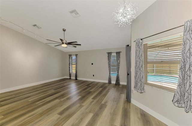5742 39th Street Cir E, Bradenton, FL 34203 - unfurnished room with ceiling fan, wood finished floors, a chandelier, and baseboards