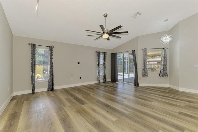 5742 39th Street Cir E, Bradenton, FL 34203 - unfurnished room with a ceiling fan, healthy amount of natural light, lofted ceiling, light wood-style flooring, and baseboards