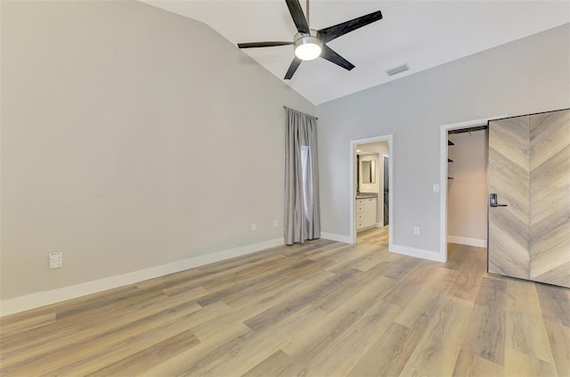 5742 39th Street Cir E, Bradenton, FL 34203 - unfurnished bedroom with vaulted ceiling, a spacious closet, light wood-style flooring, baseboards, and ensuite bath