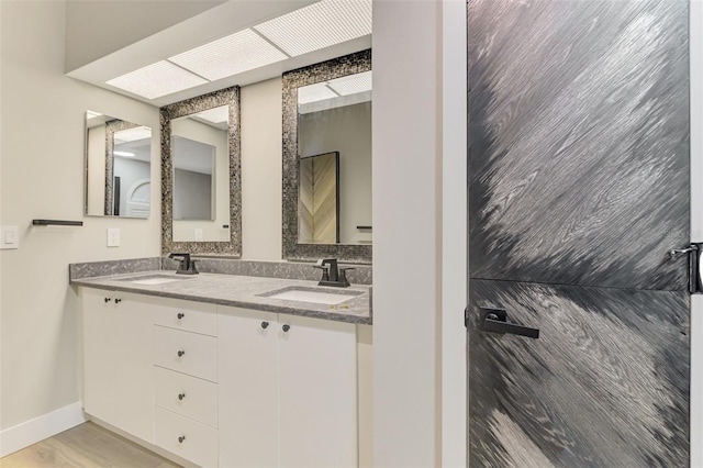 5742 39th Street Cir E, Bradenton, FL 34203 - bathroom with double vanity and baseboards
