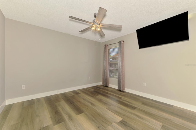 5742 39th Street Cir E, Bradenton, FL 34203 - unfurnished room with ceiling fan, wood finished floors, a textured ceiling, and baseboards