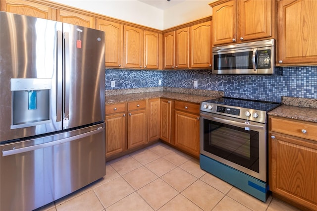 3409 10th Ln W, Palmetto, FL 34221 - kitchen with stainless steel appliances, light tile patterned floors, and brown cabinets