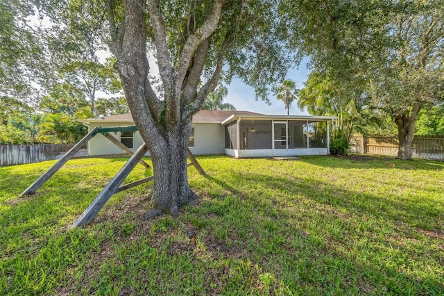 1062 Blossom Dr, Sebastian, FL 32958 - rear view of house with a sunroom