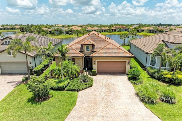 6756 Chester Trl, Lakewood Ranch, FL 34202 - view of front of property featuring a residential view, a garage, a water view, and decorative driveway