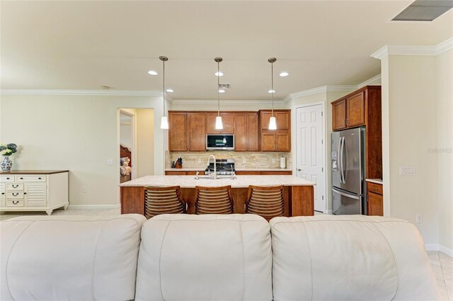 6756 Chester Trl, Lakewood Ranch, FL 34202 - kitchen featuring stainless steel appliances, open floor plan, baseboards, backsplash, and a kitchen island with sink