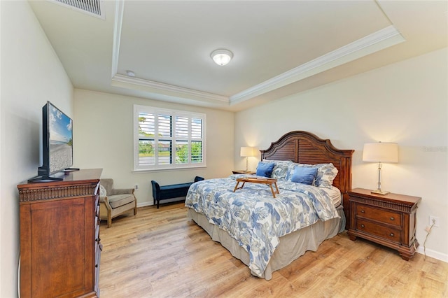 6756 Chester Trl, Lakewood Ranch, FL 34202 - bedroom with a raised ceiling, light wood-style flooring, ornamental molding, and baseboards