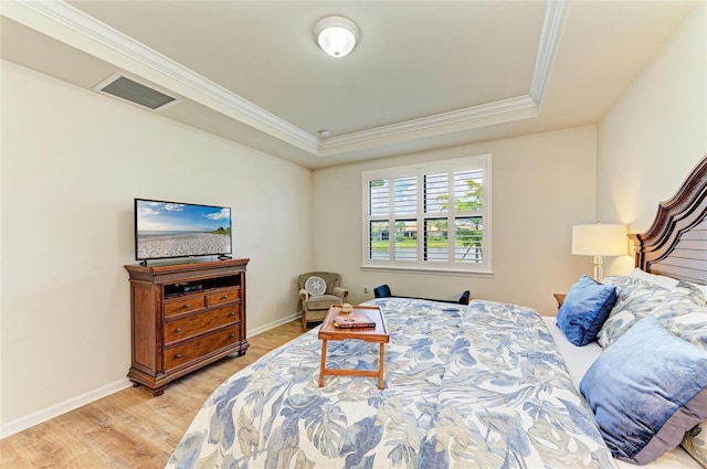 6756 Chester Trl, Lakewood Ranch, FL 34202 - bedroom featuring crown molding, a raised ceiling, light wood-style flooring, and baseboards