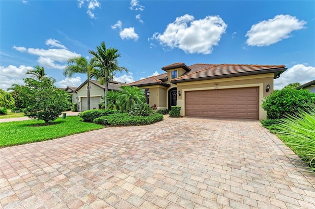 6756 Chester Trl, Lakewood Ranch, FL 34202 - view of front of property featuring stucco siding, decorative driveway, a garage, and a tiled roof