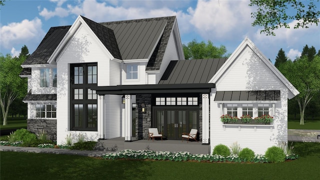 4704 Riverwood Ave, Sarasota, FL 34231 - rear view of house featuring a standing seam roof, french doors, metal roof, and stone siding