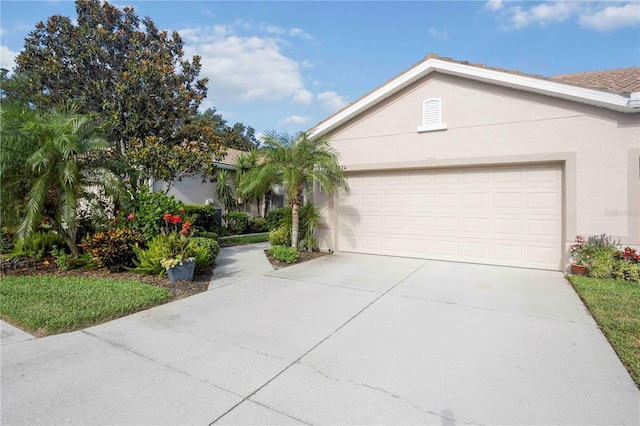 8224 Simpson Falls Ct Unit 8224, Sarasota, FL 34243 - view of front of property with an attached garage, stucco siding, and concrete driveway