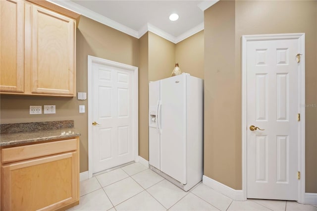 8224 Simpson Falls Ct Unit 8224, Sarasota, FL 34243 - kitchen featuring white refrigerator with ice dispenser, light brown cabinetry, ornamental molding, baseboards, and light tile patterned floors