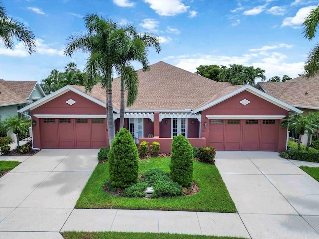 7314 Hamilton Rd, Bradenton, FL 34209 - view of front of home with an attached garage, driveway, stucco siding, and roof with shingles