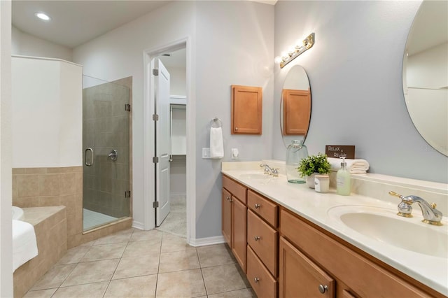 7314 Hamilton Rd, Bradenton, FL 34209 - bathroom with a shower stall, double vanity, a garden tub, tile patterned floors, and a walk in closet