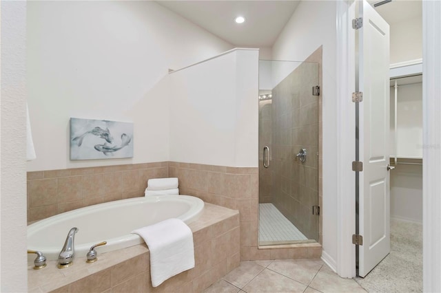 7314 Hamilton Rd, Bradenton, FL 34209 - full bathroom with a garden tub, a stall shower, a walk in closet, tile patterned floors, and recessed lighting