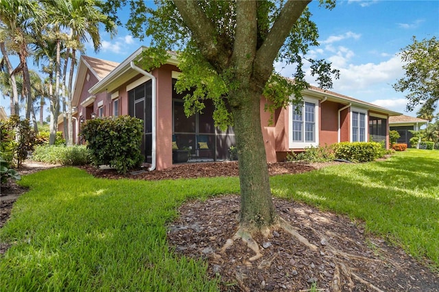 7314 Hamilton Rd, Bradenton, FL 34209 - view of property exterior featuring a sunroom, stucco siding, and a yard