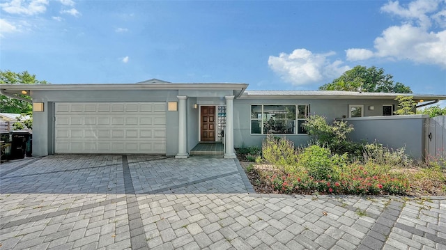 4771 Riverwood Cir, Sarasota, FL 34231 - single story home featuring a garage, stucco siding, and decorative driveway