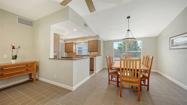 4771 Riverwood Cir, Sarasota, FL 34231 - dining room with lofted ceiling, light tile patterned flooring, and a ceiling fan