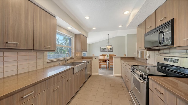 4771 Riverwood Cir, Sarasota, FL 34231 - kitchen featuring appliances with stainless steel finishes, lofted ceiling, modern cabinets, tasteful backsplash, and recessed lighting