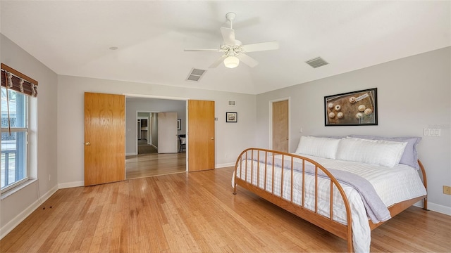 4771 Riverwood Cir, Sarasota, FL 34231 - bedroom featuring light wood-type flooring, multiple windows, and ceiling fan