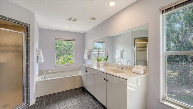 4771 Riverwood Cir, Sarasota, FL 34231 - bathroom with vanity, a stall shower, a garden tub, tile patterned floors, and recessed lighting