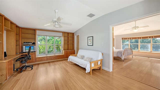 4771 Riverwood Cir, Sarasota, FL 34231 - office area featuring lofted ceiling, ceiling fan, light wood-style floors, built in study area, and healthy amount of natural light